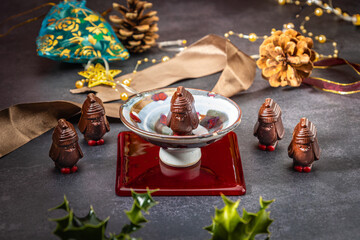 Chocolate penguins on a table with Christmas decorations