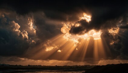 Golden sunbeams pierce dramatic storm clouds over a serene landscape
