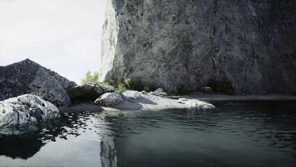 Calm waters create a mirror effect against towering rocky cliffs. Sparse greenery adorns the shore, providing a peaceful escape. Soft light enhances the tranquil scene of nature.