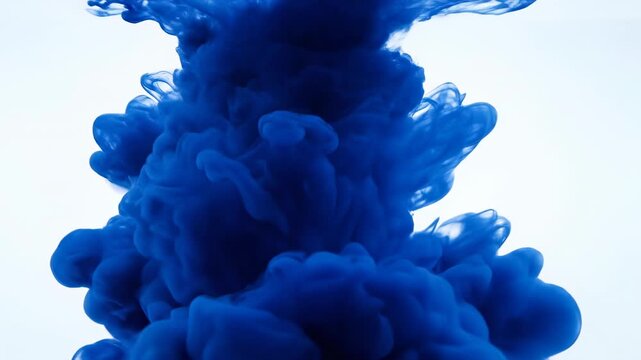 Extreme slow motion close-up shot of deep sapphire blue ink blooming and expanding dramatically underwater against a pure white backdrop creating a powerful cosmic cloud cosmic, cloud, abstract