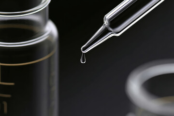 Forensic lab investigation glass dropper dispensing clear liquid precise closeup clinical equipment sterile vial pipette science