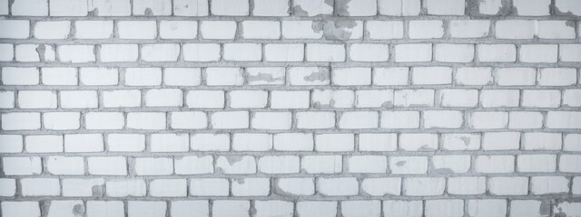 A weathered white brick wall with visible texture and slight discoloration