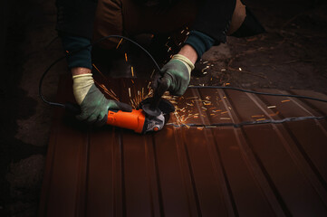 Unrecognizable worker hands close up cutting corrugated metal sheet with an angle grinder,  sparks flying, industrial construction work scene, metal fabrication process, power tool in action