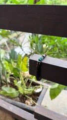 Earthy Beaded Bracelet with Turquoise Accents on Balcony Railing