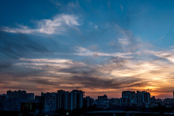 Evening scene with lit up and silhouetted buildings against a colourful evening sky at Pune India.