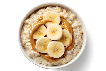 Bowl of oatmeal topped with banana slices and peanut butter on a white surface