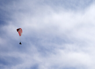 Sky gliding in cloudy sky