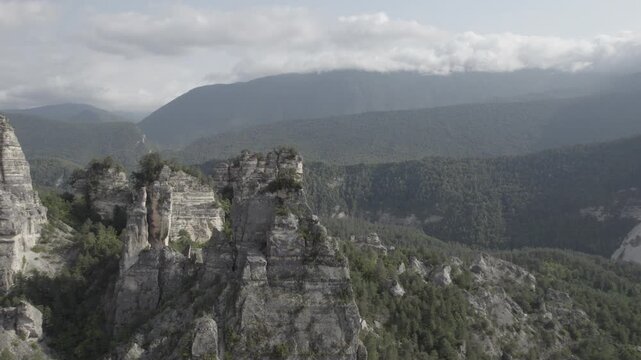 Smooth lateral drone flight revealing the Sairme Pillars in Lechkhumi, Georgia, showcasing striking rock formations rising from the natural landscape. 