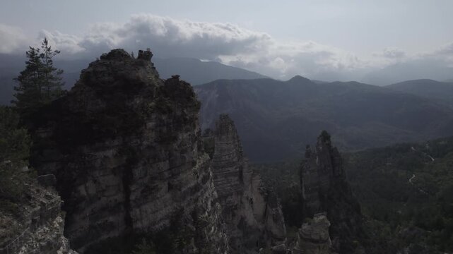 Aerial drone footage capturing the Sairme Pillars in western Georgia, soaring stone formations rising from lush hills in the remote Lechkhumi region. High-quality cinematic 4K video.