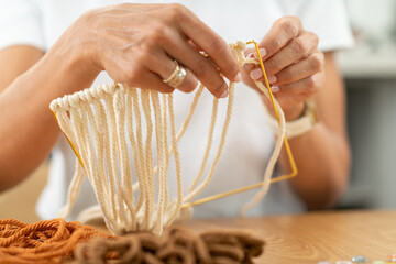 Creating tapestry in a relaxed home craft corner. Emphasizes patience, fine-motor work, and slow textile creation.