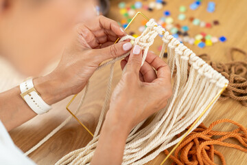Weaving tapestry in a small home studio with organized materials. Highlights structure, clarity, and artistic textile development.