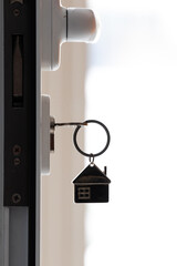 house keychain with keys in the door lock