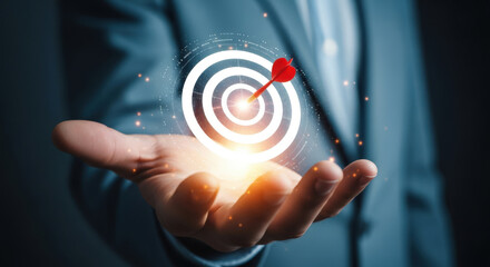 Achieving Business Goals A Hand Holding a Target with an Arrow Hitting the Bullseye, Representing Success, Precision, and Strategic Aim in a Corporate Setting