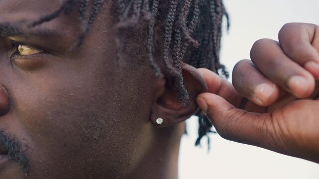 Leader Reviews Accessories Calmly, Uniformed Sergeant Carefully Checks His Stud Earring Attentively, Sharpdressed Military Sergeant Ensures His Stud Earring Is Properly In Place Before Duty