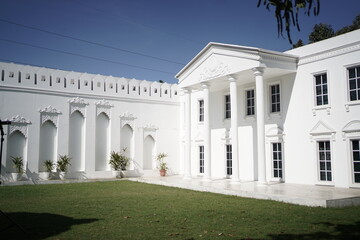 Elegant white mansion with classic architecture and beautiful garden