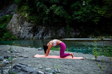 Japanese woman practicing yoga and relaxation in nature