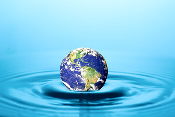 A mesmerizing conceptual image featuring the Earth afloat in a ripple of water, evoking a sense of our planet's fragility and the importance of environmental conservation. 
