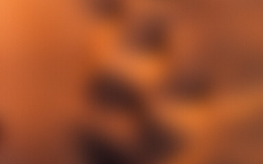 Abstract orange bokeh background with glowing light and warm fiery textures
