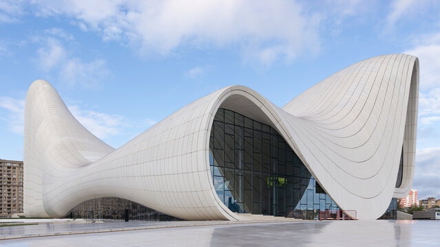 Baku, Azerbaijan - May 7, 2024: The iconic Heydar Aliyev Centre, showcases modern architecture with its fluid, wave-like design against a clear sky. Building designed by architect Zaha Hadid