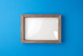 Wooden desktop photo frame modern style, picture frame on blue background