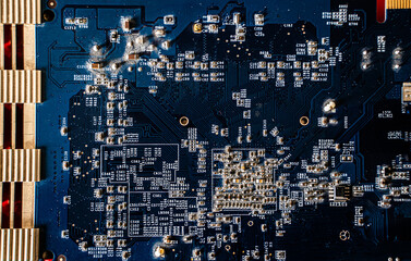 Microchip mounted on a red printed circuit board. Electronics, hardware and technology concept.