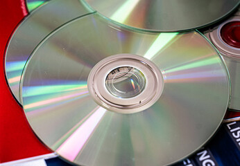 Optical discs CDs and DVDs arranged as a shiny background. Digital storage and multimedia concept.