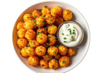 Crispy golden potato bites with creamy dip, sprinkled with chives