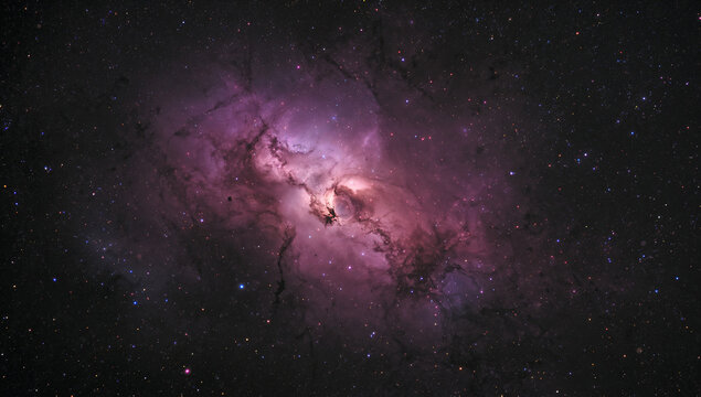 Stunning wide field astrophotography capture of the majestic magenta and purple colors of the Lagoon Nebula M8