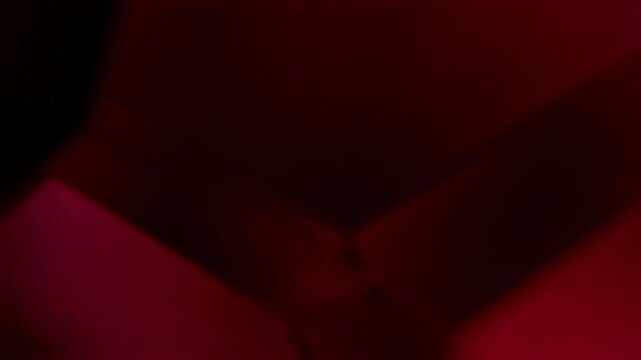 Red Geometric Forms Seamless Loop. Minimalist blurred crimson and burgundy abstract planes slowly shifting in elegant low-key rotation.