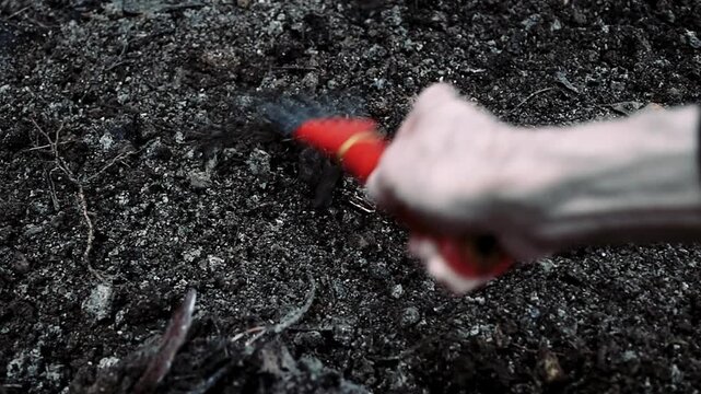 Shot depicting weeding and preparation of wet soil