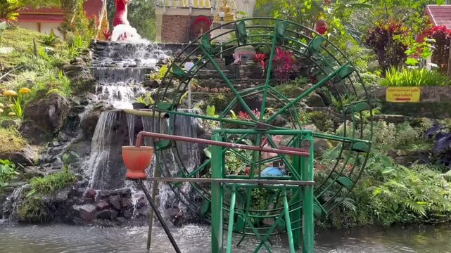 Traditional wooden water wheel turning gently in rural landscape, using flowing stream to lift water for irrigation and farming, symbol of sustainable living