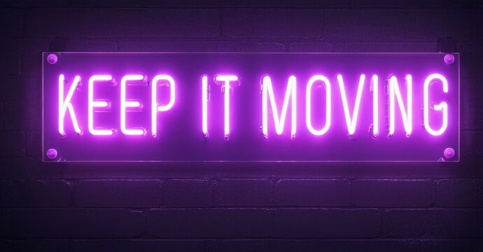 Bright purple neon sign displays motivational phrase Keep It Moving against textured brick wall. Simple, modern aesthetic.