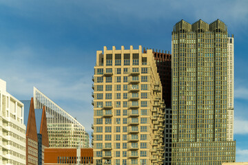 View of modern architecture with striking angles and textures rise against a brilliant blue sky, creating a dynamic urban landscape, The Hague, South Holland, Netherlands.
