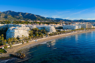 Luxury Living at Dawn: Cinematic 4K Aerial of Marbella&rsquo;s Golden Mile, Featuring Exclusive Beachfront Resorts, the Paseo Mar&iacute;timo, and La Concha Mountain, Costa del Sol, Spain