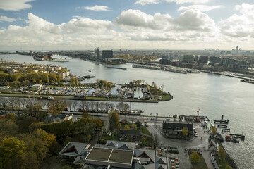 Aerial view of the shimmering waters reflecting the sky, cutting through the heart of the city, with the iconic buildings standing tall, Amsterdam, North Holland, Netherlands.