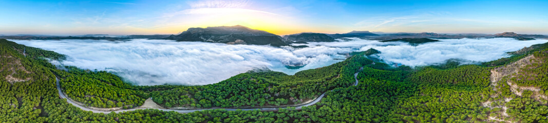 Aerial Sunrise Above the Clouds at Caminito del Rey, Guadalhorce Lake, and the Pine Forests of Andalusia, Spain