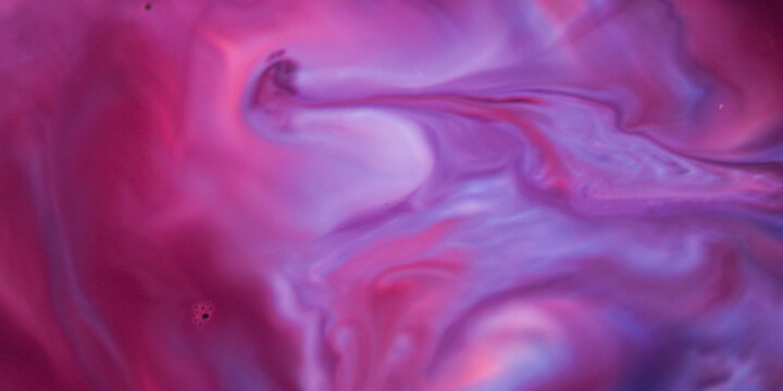 An abstract background of liquid marble texture in a vibrant blend of magenta, purple, and blue. The flowing effect of ink or paint blending gently creates an artistic and imaginative visual compositi