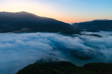 Aerial Sunrise Above the Clouds at Caminito del Rey, Guadalhorce Lake, and the Pine Forests of Andalusia, Spain