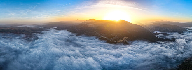 Aerial Sunrise Above the Clouds at Caminito del Rey, Guadalhorce Lake, and the Pine Forests of Andalusia, Spain