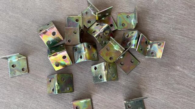 Steel L-Brackets Scattered on Ground Showing Construction Hardware and Angle Support Components