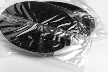 Packaged water filter spare part sealed in transparent plastic. Filtration system component on white table 