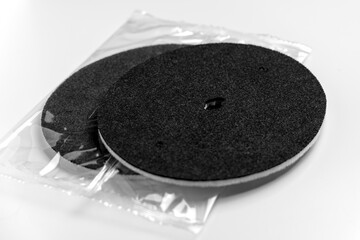 Clean new industrial water filters with black fiber texture on white table