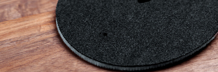 Round clean filters with black fibrous texture on wooden countertop. Water purification system spare part