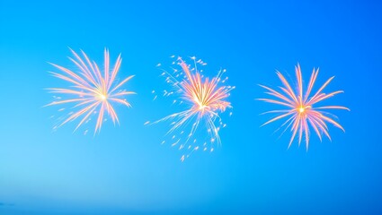 Three bright orange fireworks exploding in a clear, vibrant blue twilight sky.