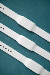 White waterproof access key bracelets with a microchip. Functional gadget with an RFID bracelet. Contactless silicone access key.