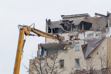 High reach excavator tearing down old apartment block for urban redevelopment © Viktoryia