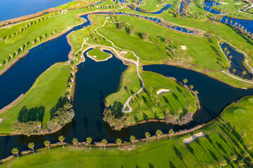 The Ultimate Retirement Dream: Cinematic Aerial Flyover of Salgados Golf Course Nestled Between the Atlantic Ocean and Natural Lagoons in Algarve, Portugal