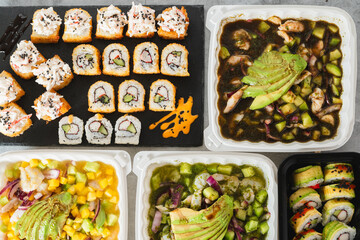 Diverse seafood spread featuring different types of sushi rolls and aguachile dishes
