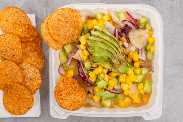 Colorful shrimp and fish aguachile with avocado, mango, cucumber, and red onion served with chips.