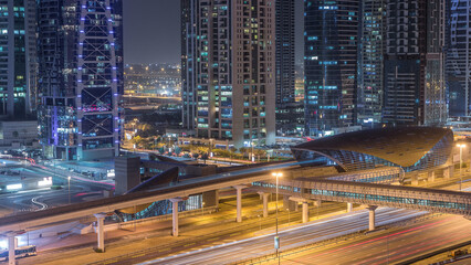 Fototapeta premium Aerial view of Jumeirah lakes towers skyscrapers day to night timelapse with traffic on sheikh zayed road.